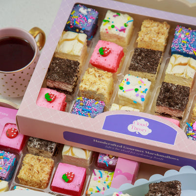 Box of Cloud Theory marshmallows with a cup of coffee on a white plate