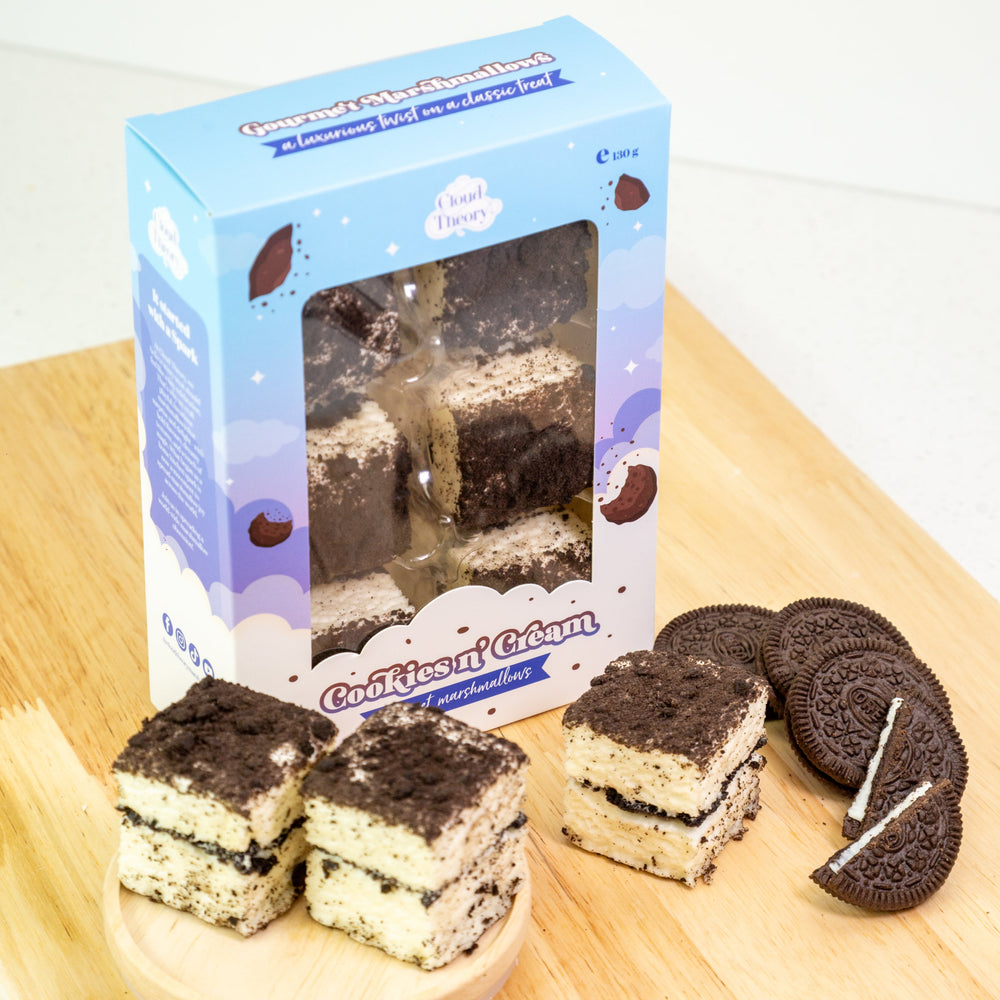 Oreo-flavored cake slices and packaging on a wooden board with a white background