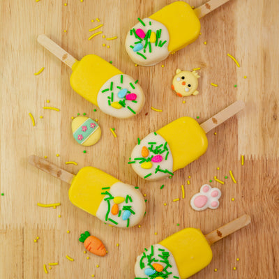 Easter Edition Dream Pop featuring a fluffy marshmallow in the shape of a popsicle, dipped in creamy white chocolate and decorated with festive Easter sprinkles. A perfect Easter gift or party treat.