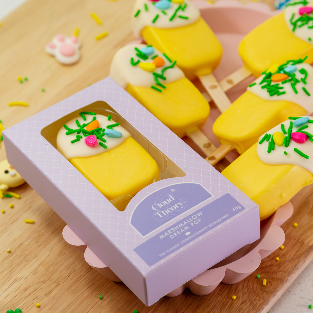 Easter Edition Dream Pop featuring a fluffy marshmallow in the shape of a popsicle, dipped in creamy white chocolate and decorated with festive Easter sprinkles. A perfect Easter gift or party treat.