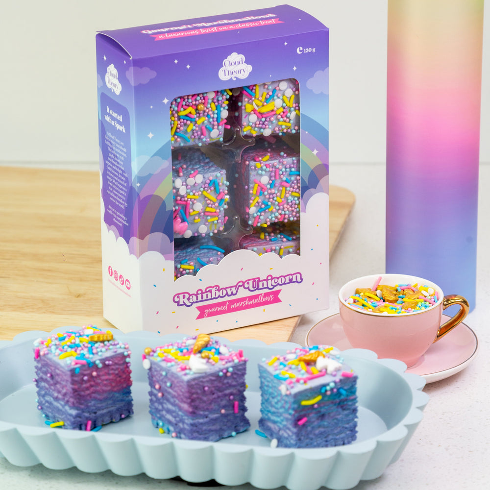 Colorful candy bars with a 'Rainbow Unicorn' packaging on a white surface.