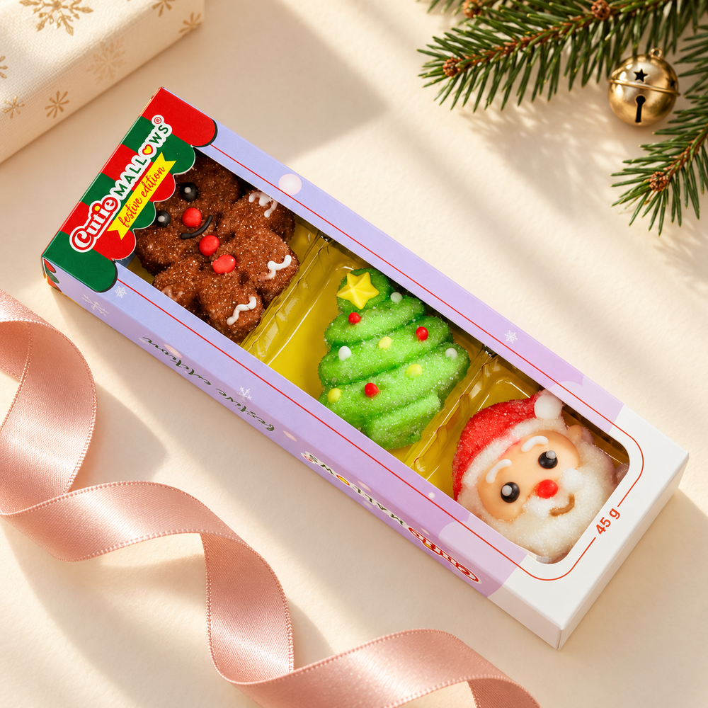 Cutie Mallows Christmas 3-piece sleeve beside pink ribbon and festive greenery
