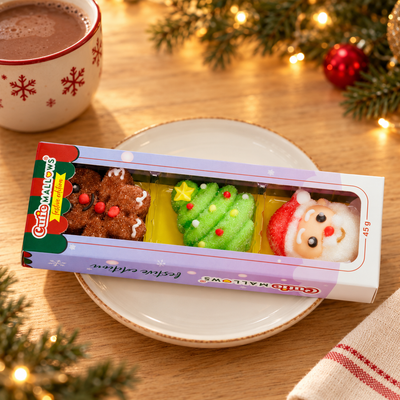 Cutie Mallows Christmas 3-piece sleeve on a plate beside a festive mug and Christmas lights