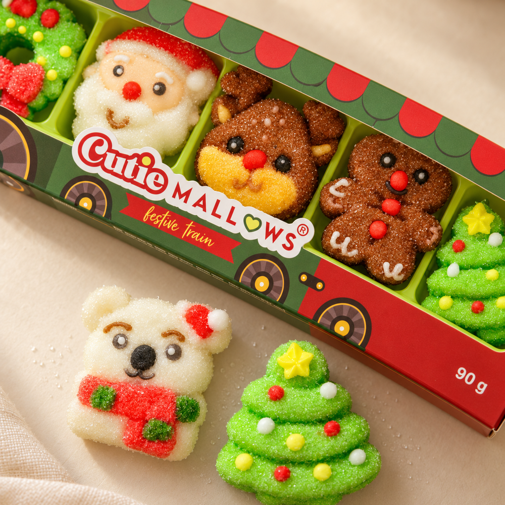 Close-up of Cutie Mallows Christmas Train marshmallow gummies with loose bear and Christmas tree sweets