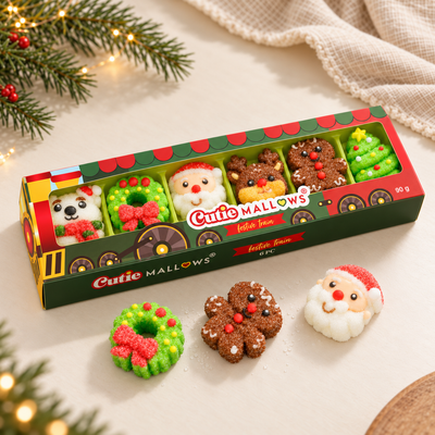 Three-quarter view of the Cutie Mallows Christmas Train gift box with loose wreath, gingerbread and Santa marshmallow gummies
